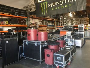 lots of road cases full of backline gear waiting to be loaded in a truck